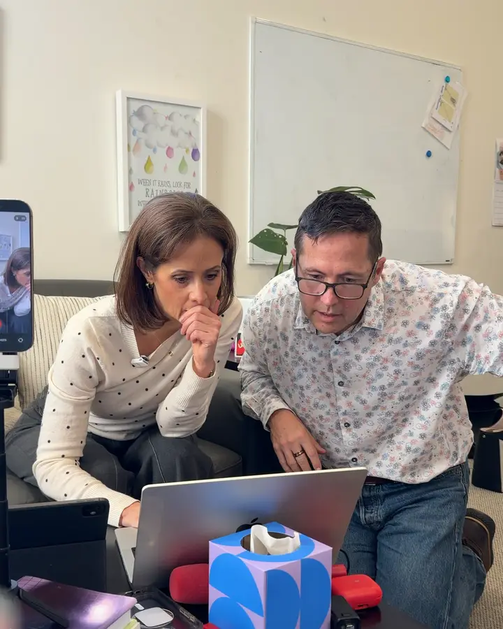 Two business owners reviewing their footage on a laptop